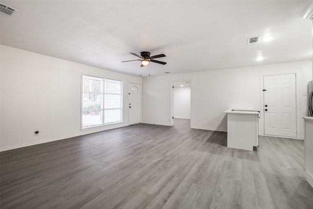 spare room with light wood-type flooring and ceiling fan