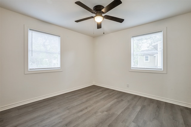 spare room with ceiling fan and dark hardwood / wood-style flooring