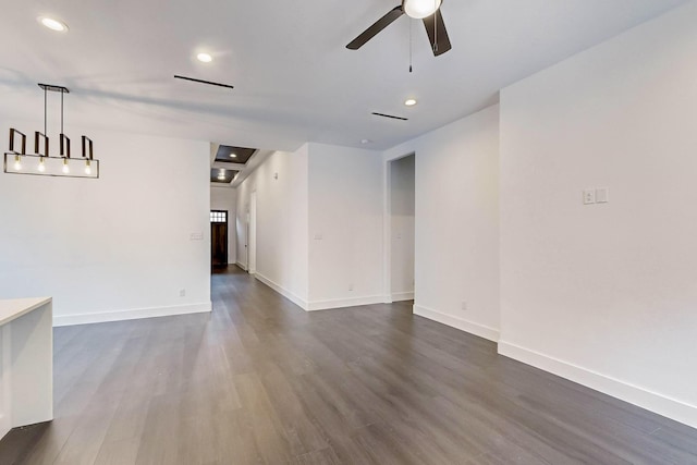 empty room with dark wood finished floors, recessed lighting, baseboards, and a ceiling fan