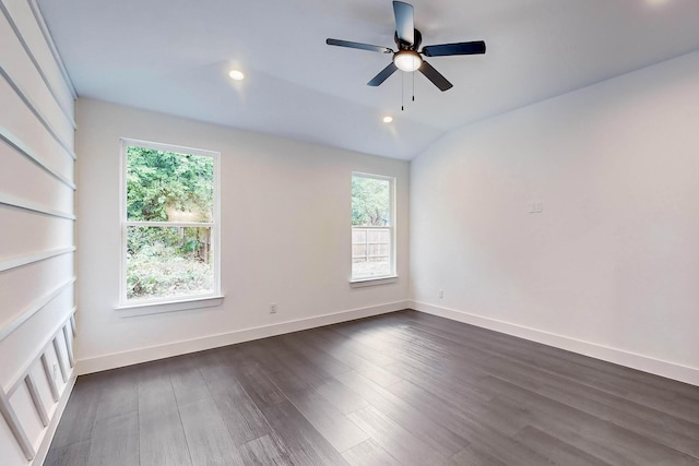 spare room featuring baseboards, lofted ceiling, recessed lighting, a ceiling fan, and dark wood-style flooring