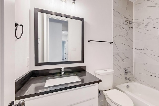 bathroom featuring toilet, bathtub / shower combination, and vanity