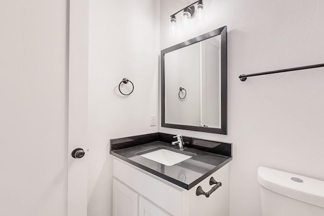 bathroom featuring toilet and vanity