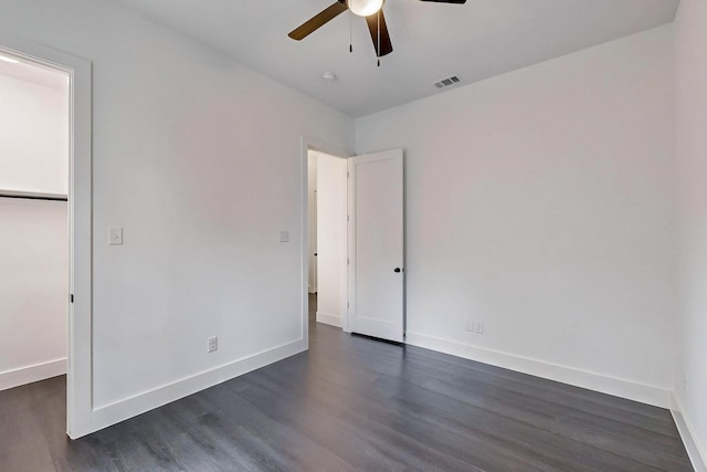 unfurnished bedroom with visible vents, baseboards, and dark wood-style flooring