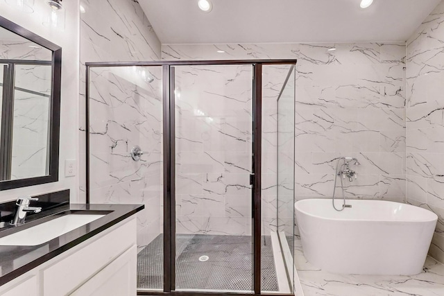 full bath with marble finish floor, recessed lighting, a marble finish shower, a freestanding bath, and vanity