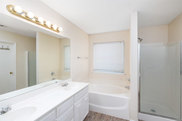 bathroom featuring vanity, wood-type flooring, and separate shower and tub