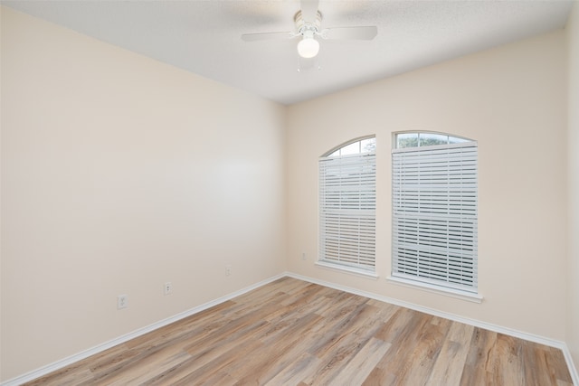 empty room with light wood-type flooring and ceiling fan