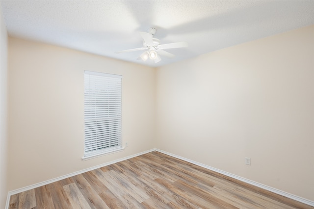 spare room with light hardwood / wood-style flooring, a textured ceiling, and ceiling fan