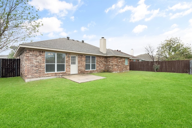 back of house featuring a patio and a lawn