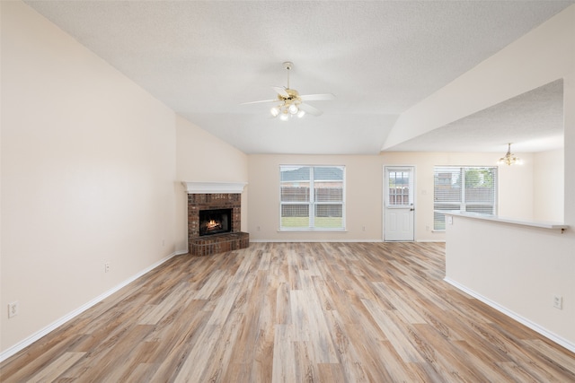 unfurnished living room with light hardwood / wood-style flooring, plenty of natural light, and a fireplace