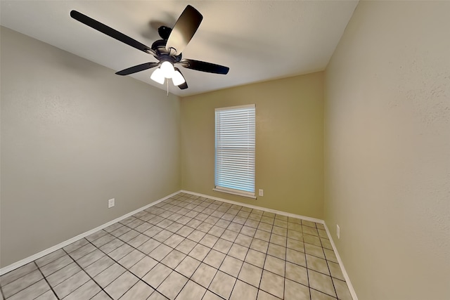 tiled spare room with ceiling fan