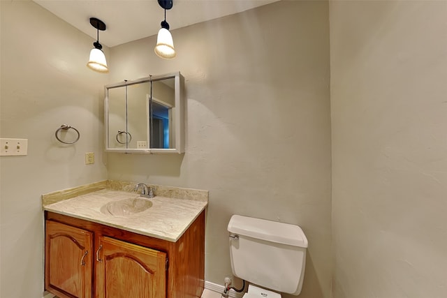 bathroom with toilet and vanity