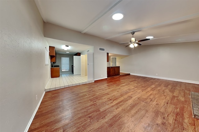 unfurnished living room featuring light hardwood / wood-style floors and ceiling fan