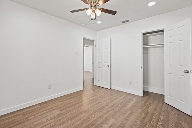 unfurnished bedroom with wood-type flooring, a closet, and ceiling fan