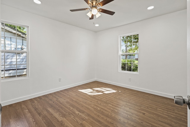 unfurnished room featuring dark wood-type flooring and ceiling fan