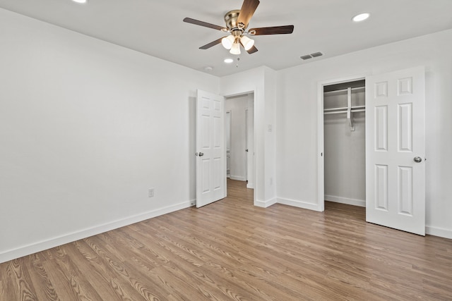 unfurnished bedroom with light hardwood / wood-style floors, a closet, and ceiling fan