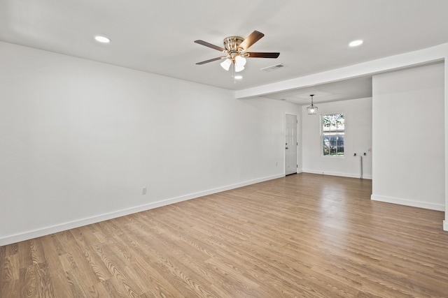 spare room featuring light hardwood / wood-style flooring and ceiling fan