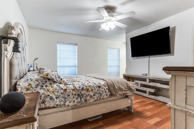 bedroom with ceiling fan and hardwood / wood-style flooring