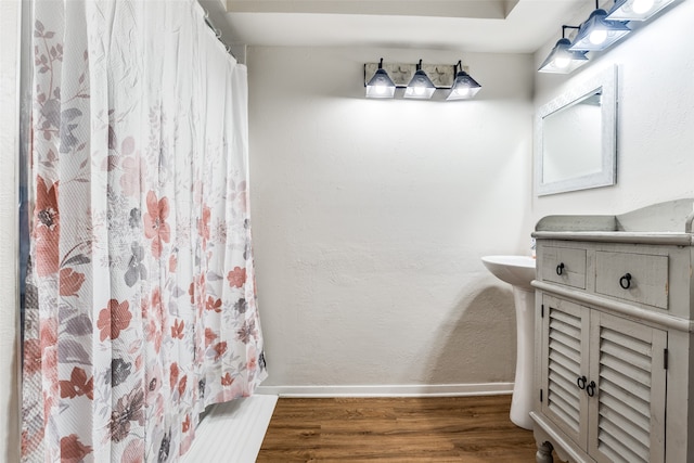 bathroom featuring vanity, hardwood / wood-style flooring, and walk in shower