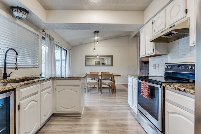 kitchen featuring lofted ceiling, wine cooler, sink, white cabinets, and stainless steel electric range oven