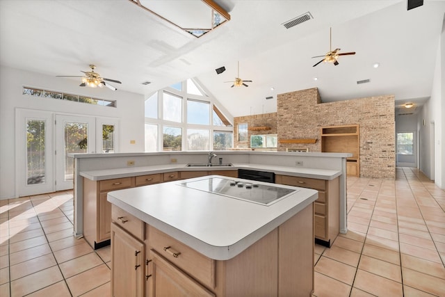 kitchen featuring a center island, high vaulted ceiling, and plenty of natural light