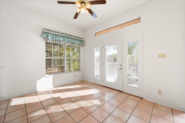 entryway featuring ceiling fan, french doors, and light tile patterned floors