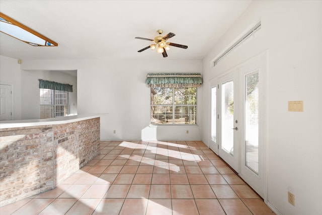 interior space featuring light tile patterned floors, french doors, and ceiling fan