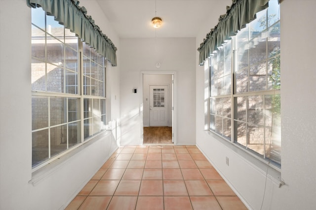 interior space with a healthy amount of sunlight and light tile patterned floors