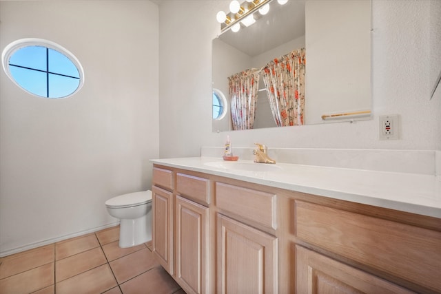 bathroom featuring tile patterned floors, a shower with curtain, vanity, and toilet