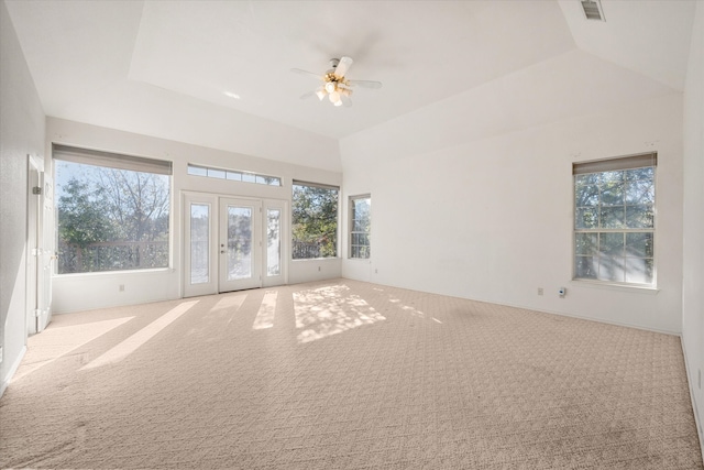 unfurnished living room featuring light carpet, french doors, ceiling fan, and lofted ceiling