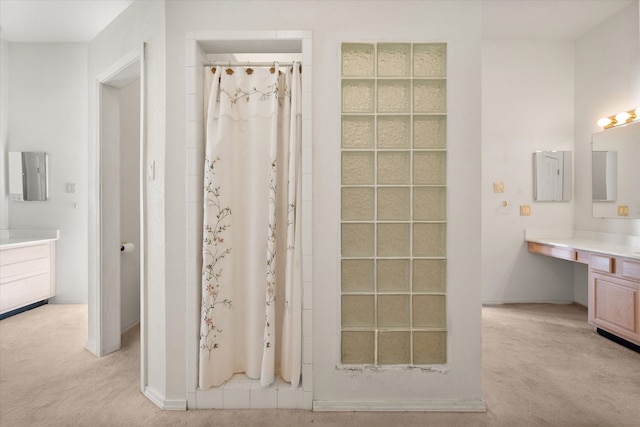 bathroom featuring a shower with curtain and vanity