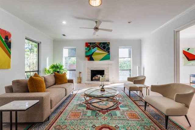 living room with ceiling fan and ornamental molding