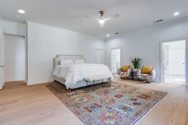 bedroom with connected bathroom, light hardwood / wood-style floors, ceiling fan, and ornamental molding