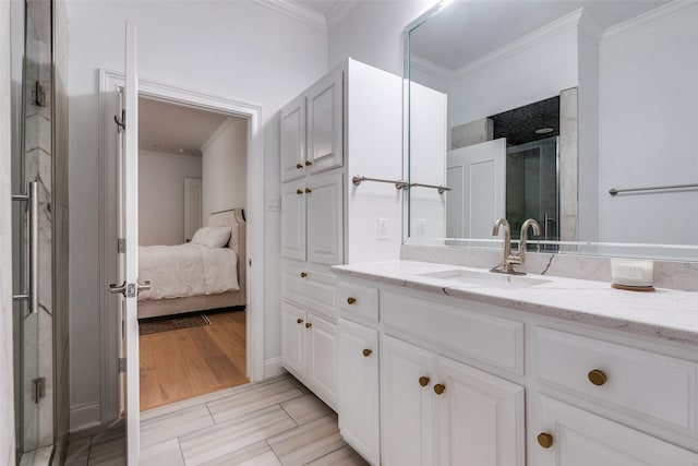 bathroom featuring crown molding, hardwood / wood-style floors, vanity, and an enclosed shower