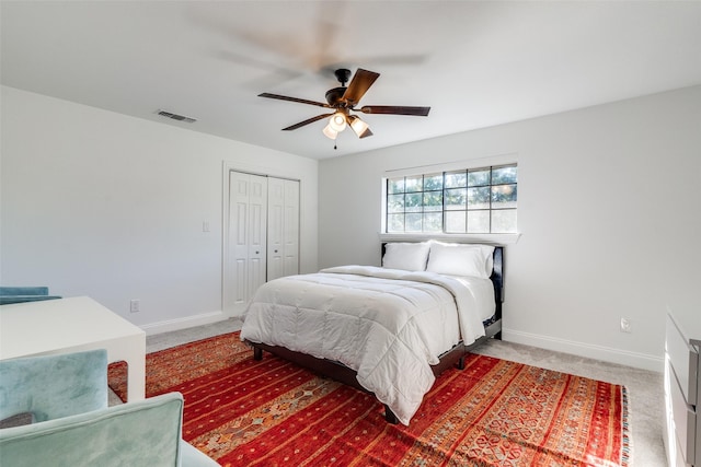 bedroom with ceiling fan, a closet, and carpet