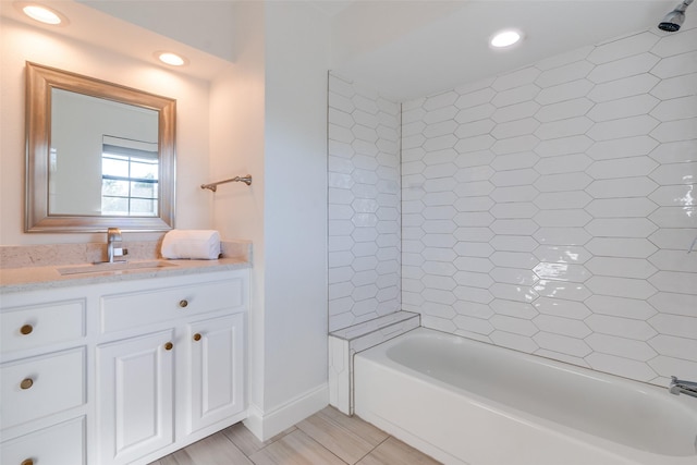 bathroom with vanity and tiled shower / bath combo