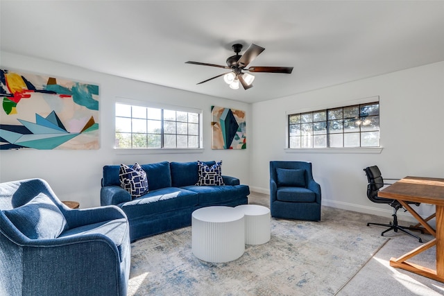 carpeted living room with ceiling fan