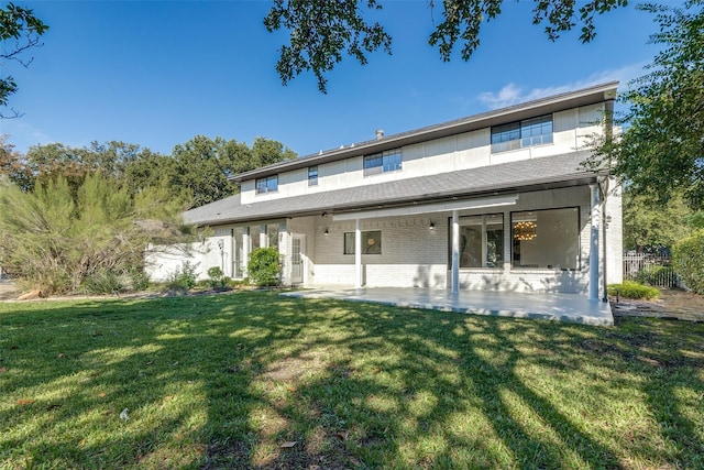 rear view of property with a patio area and a yard