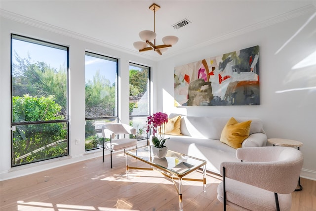 sunroom / solarium with a chandelier