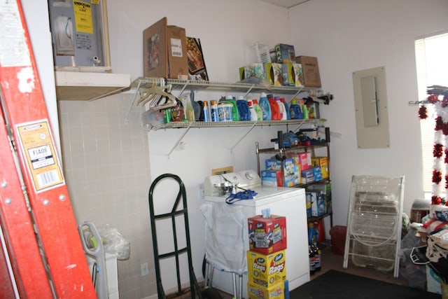 interior space featuring water heater, electric panel, plenty of natural light, and washer / dryer