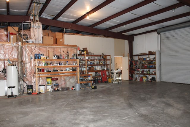 garage featuring a workshop area and water heater