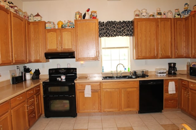 kitchen featuring black appliances, sink, and light tile patterned floors