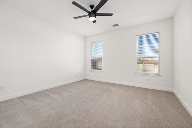 carpeted empty room featuring ceiling fan