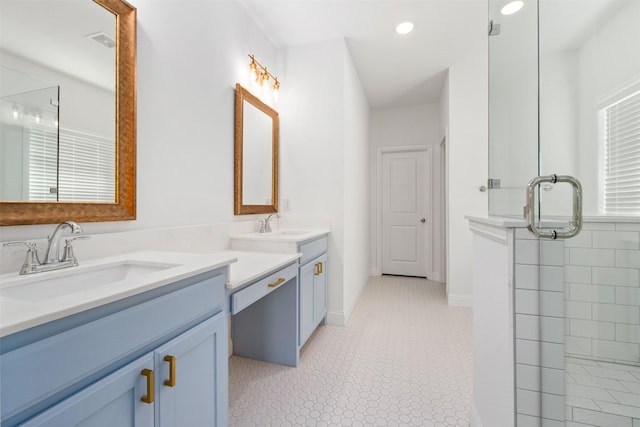 bathroom featuring a shower with door, vanity, and tile patterned flooring