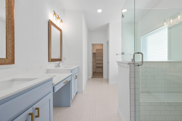 bathroom featuring an enclosed shower, vanity, and tile patterned floors