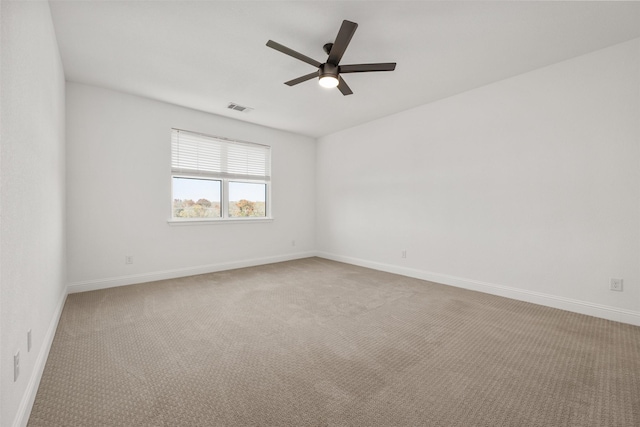 carpeted spare room featuring ceiling fan