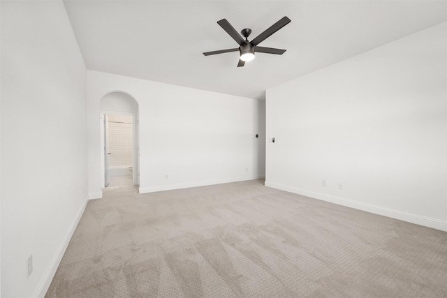 spare room featuring ceiling fan and light colored carpet