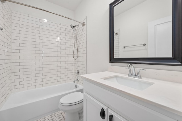 full bathroom featuring toilet, tiled shower / bath, tile patterned floors, and vanity