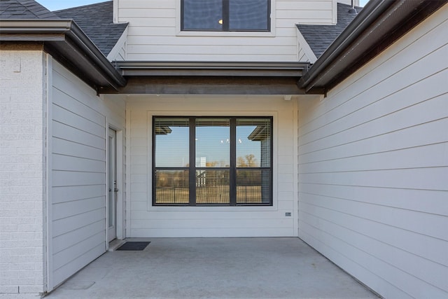 view of exterior entry featuring a patio