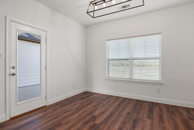 unfurnished room with dark hardwood / wood-style floors