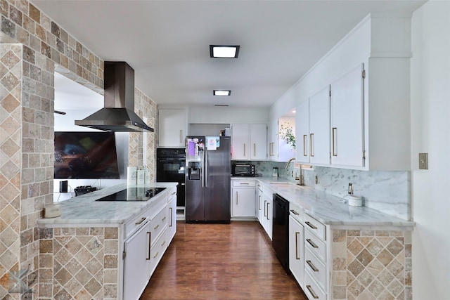 kitchen featuring decorative backsplash, dark hardwood / wood-style flooring, wall chimney exhaust hood, black appliances, and white cabinets